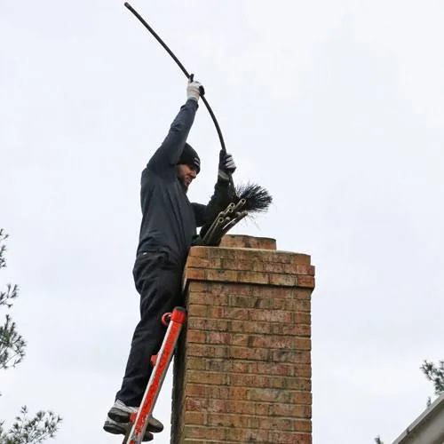 Chimney sweep using a long brush to service a brick chimney flue